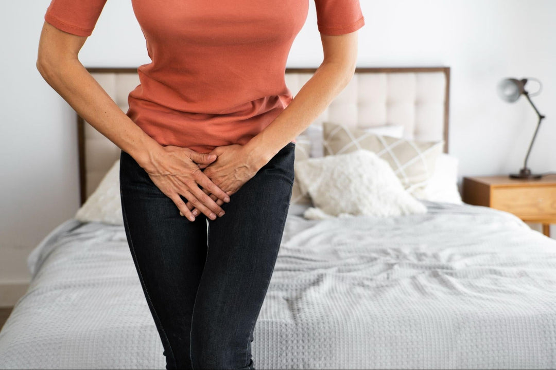  Woman experiencing pelvic pain or discomfort in bedroom at home